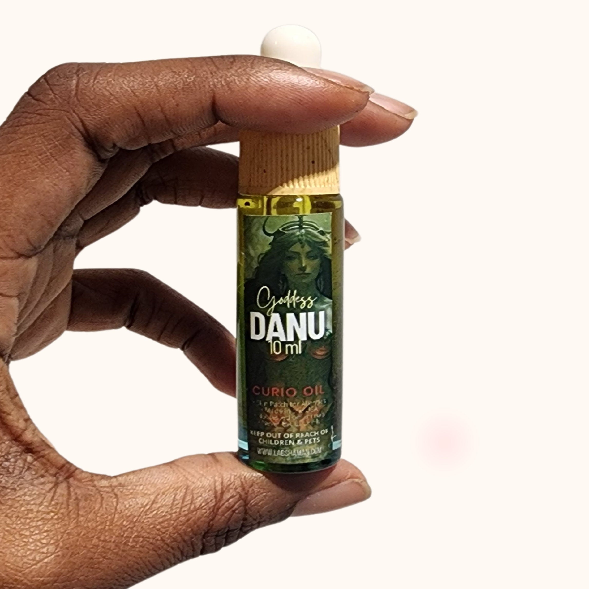 LAB Shaman&#39;s Danu Oil, encased in a glass vial, symbolizes fertility and abundance. With a clear green quartz, the oil reflects the essence of Danu, the Celtic Mother Goddess.