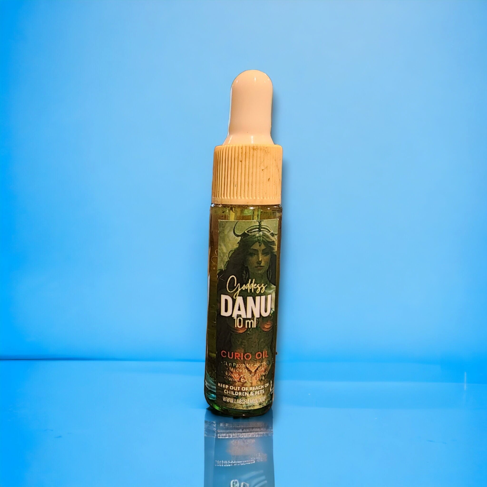 LAB Shaman&#39;s Danu Oil, encased in a glass vial, symbolizes fertility and abundance. With a clear green quartz, the oil reflects the essence of Danu, the Celtic Mother Goddess.